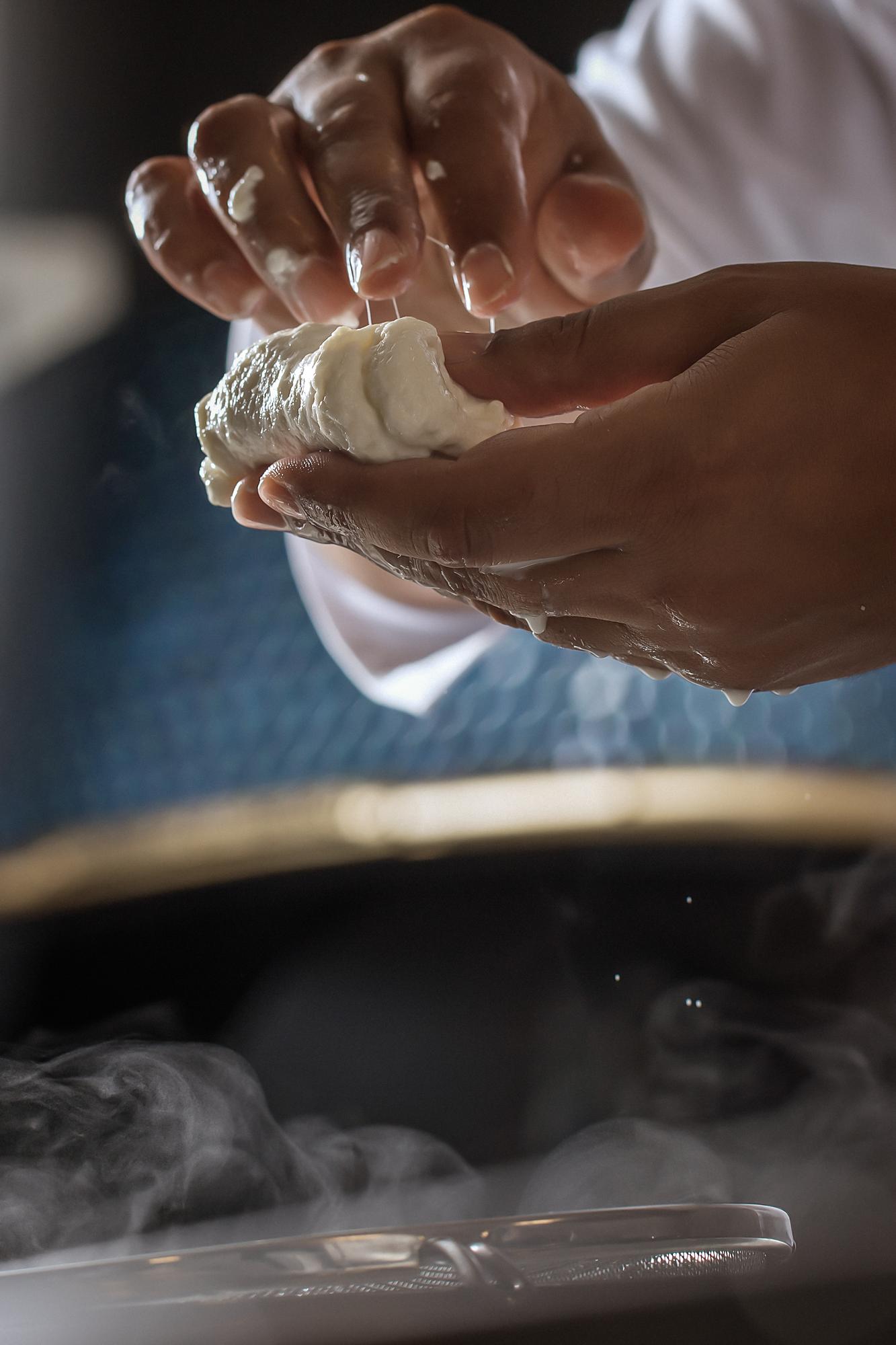 Close-up of chef hands kneading dough